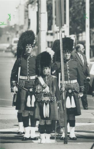 Centennial march. Members of the 48th Highlanders parade on Queen's Park Cres. yesterday to mark the 100th anniversary of the regiment's founding