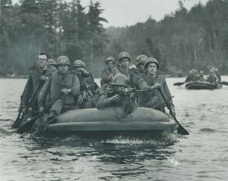 School for war in Ontario's north woods includes capture of a dam by officer candidates who paddle in to attach on inflated rubber boat. Exercise Poli(...)
