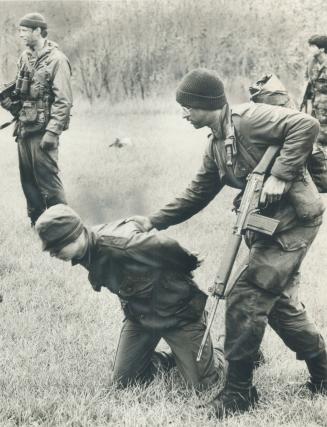 Down on your knees: It looked like real warfare on Toronto Islands as local militiamen pretended they were commandos engaging an enemy in guerrilla warfare