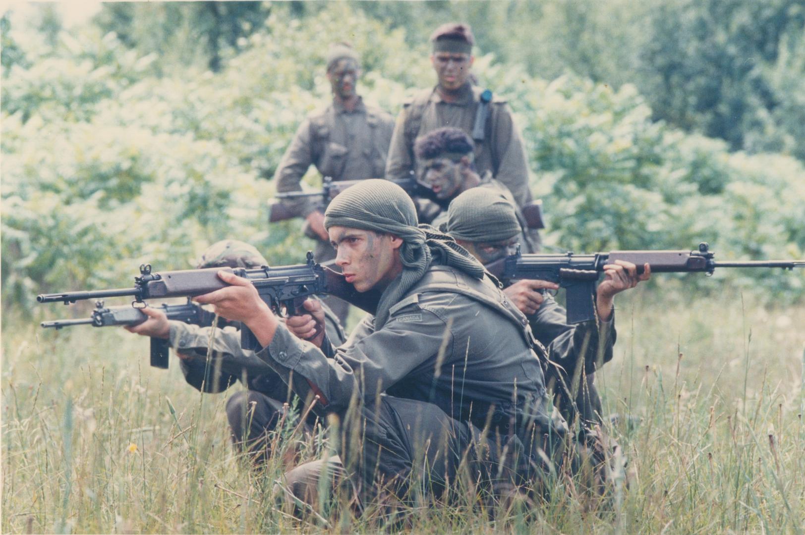 Reserve unit: Ontario Regiment recruits from Oshawa are poised for combat at the Ganaraska Conservation Area during a one-week field training program, part of a three-month summer program