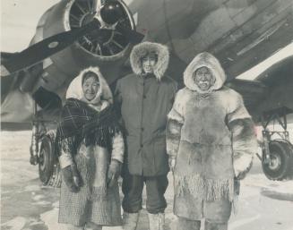 Looking like a native, F.O. Bill Alwood of St. John, N.B., a member of Muskox expedition, posed with two Eskimos at Baker Lake. The first half of the (...)
