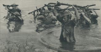 A scout party of British jungle fighters of Field Marshal Wavell's forces are shown here wading through a stream in Burma