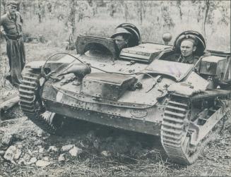 Two British soldiers take a ride in a miniature tank of French make which was captured from the enemy in the breakthrough to Rome a few weeks ago. The(...)