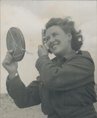 A nurse needs to be attractive even on the desert, as this one with the Eighth Army finds