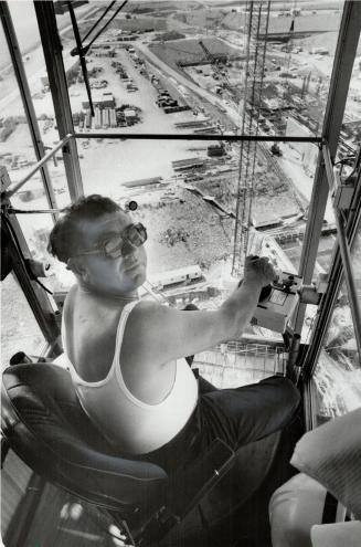 Crane operator (right) works one of the world's largest mobile cranes