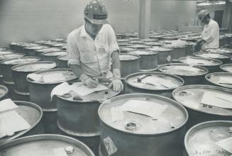 Stainless steel drums of heavy water crowd nuclear generating plant storeroom, the vital ingredient, in making electrical power. Shortages and high pr(...)