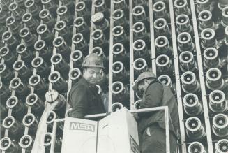 Deep in the heart of one four nuclear reactors at Pickering power station, technicians prepare tubes that will contain fuel rods when the plant begins producing power within tow months