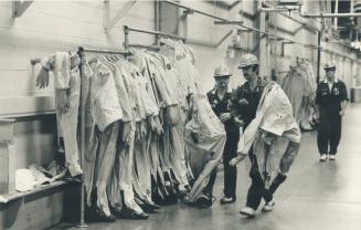 Workers technicians getting into their safety suits before entering reactor 2