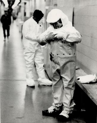 Technicians suiting up before a shift inside the reactor