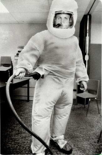 Ready for anything. Ontario Hydro safety specialist Michael Eisner sports a plastic safety suit intended to guard against radioactivity from leaks of (...)