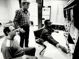 Standing is Frank Raby Teaching Operators Errol Daw at controls Jim Carroll in forground