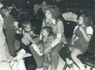 Mother Karen Cole huddles with children in evacuation centre