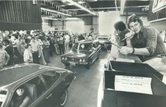 Auctioneer Bob Dickenson (right) plies his trade at the car auction in Mississauga, where dealers buy their cars