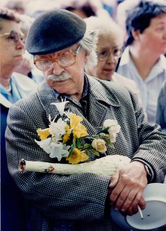 Bill Sterne carries genuine plastic flowers