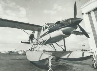 Pilot Wally Warner stands on the pontoon of an amphibious Turbo Beaver aircraft, at Malton International Airport, one of four planes used by the Ontar(...)