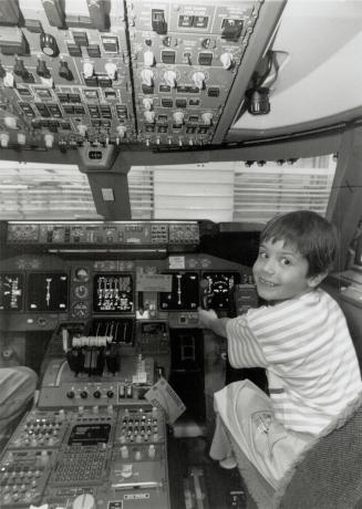 In charge: Jane Doe tries her hand at the controls of a 747 and her look indicates she's up to the task for takeoff