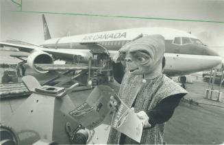 World traveller: E. T. studies the information kit for Air Canada's new Boeing 767, probably to see how far it can go on a tank of gas. While it has t(...)