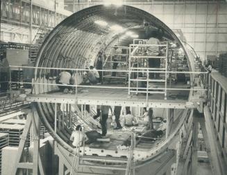 Workmen on two levels carry out individual tasks on two levels in a section of TriStar that is in a much earlier stage of assembly than Air Canada's a(...)