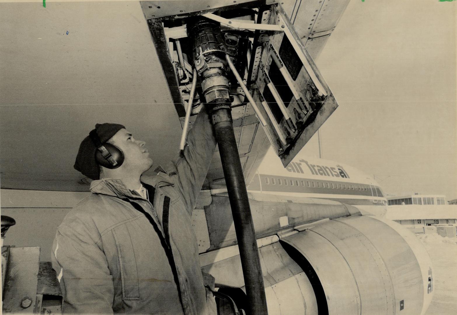 Freehand fuelling. Max D' Arsie of Consolidated Aviation refuels a Tristar at Pearson International Airport last week. A break in a fuel pipeline mean(...)