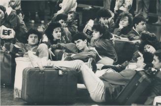 Studetns from Nova Scotia spread out as they await flights at jam-packed Pearson International Airport yesterday
