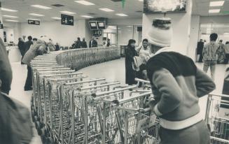 Carts for rent: Travellers using Pearson airport's Terminal 3 have to pay to use luggage carts but the $1 fee is refunded when the carts are returned