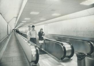Moving sidewalk tunnel at Toronto International Airport, reader says below, is used by only 200 people a day