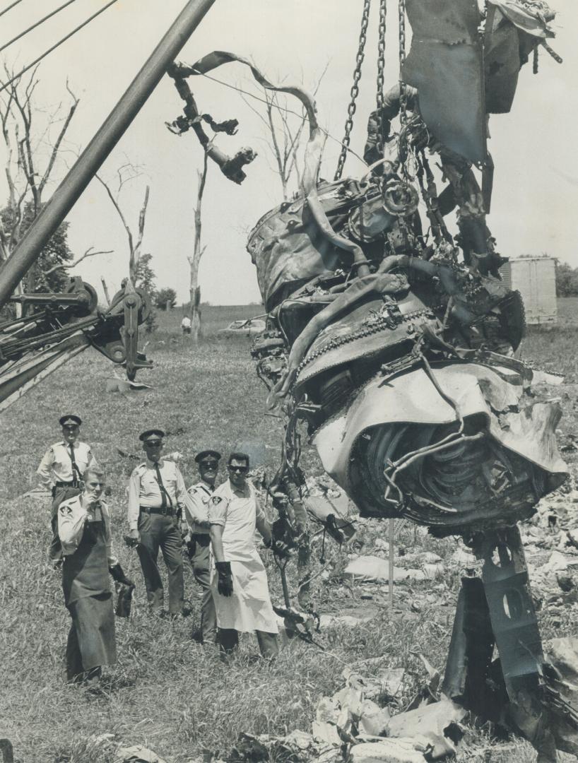 Smashed jet engine, from the Air Canada DC-8 airliner that plunged to each Sunday north of Toronto International Airport, is hoisted by a crane yester(...)