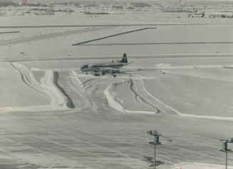 Snowplow tries to clear air canada viscount from the deserted drifts that clogged malton airport