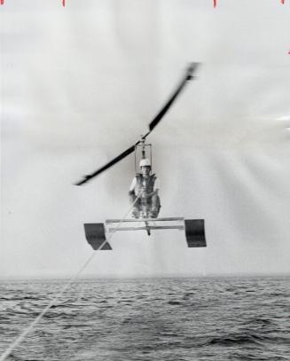 A Gyrocopter gets a tow. Cliff Lucky of Bronte flies 50 feet into the air in his home-made gyrocopter, pulled by a 165-horsepower boat. Next week he'l(...)