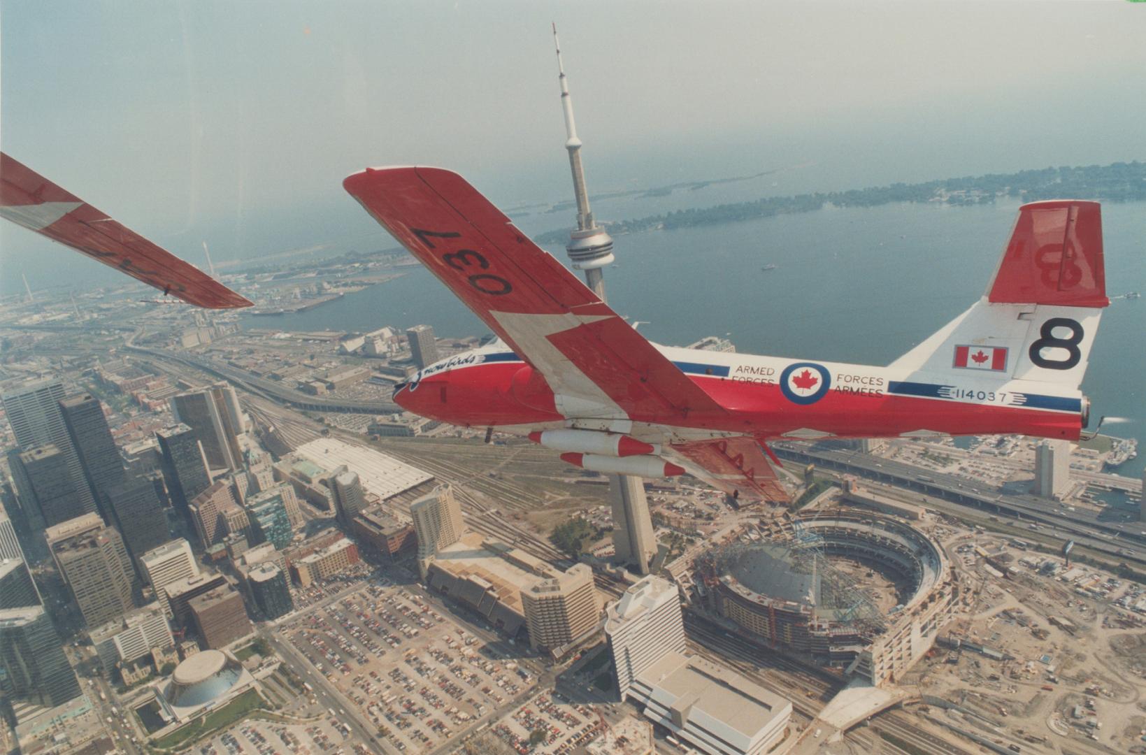 Snowbirds roar over metro. Capt. Wes MacKay banks his Canadian Forces Tutor jet over downtown Toronto yesterday in a practice run before he and fellow(...)