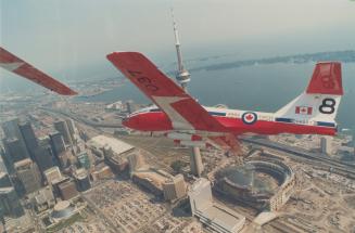 Snowbirds roar over metro. Capt. Wes MacKay banks his Canadian Forces Tutor jet over downtown Toronto yesterday in a practice run before he and fellow(...)