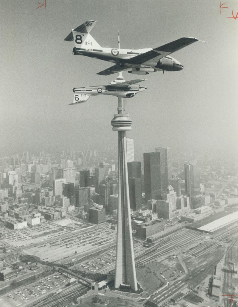 Pole position. No, these Canadian Forces jets are not impaled on the CN Tower. Ten feet apart, two Tutor trainers of the Snowbirds aerobatic team make(...)