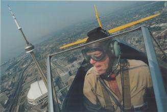 Pilot Murray Kot, 45, yells in delight yesterday as he circled the city in a 1945 PT17D Stearman while preparing for the CNE air show this weekend
