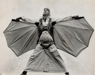 Wings outstretched, Clem Sohn show the structure of his flying equipment