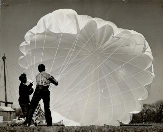 Making and testing of a parachute is illustrated in pictures taken at a Canadian plant now engaged in large-scale production. Here is a 'chute with a test dummy just landing. [Incomplete]