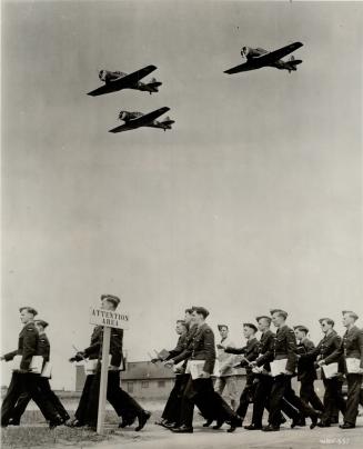 Daily hundreds of recruits in the Uplands training school march off to class, books under their arms, while trainers fly overhead