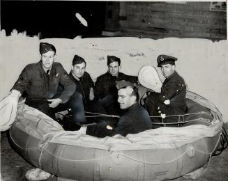 When their plane crashed into Lake Erie, the lives of these airmen were saved by this dinghy in which they are sitting