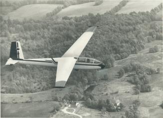 High above the Caledon Hills, Star reporter Ann Farrell flies in a glider with pilot Neil Poole of the Erin Soaring Society. Society president Peter R(...)