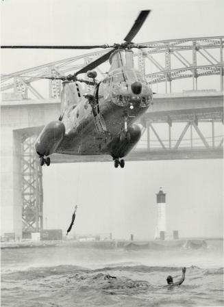 A model rescue operation. A twin-rotor Labrador helicopter from the crack Canadian Forces search-and-rescue team hoist a man to safety from chilly Bur(...)