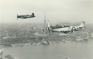 Taking flight. World War II fighter planes, including a Corsair, left, and a Mustang, flew over Toronto yesterday in a preview of the Hamilton Interna(...)