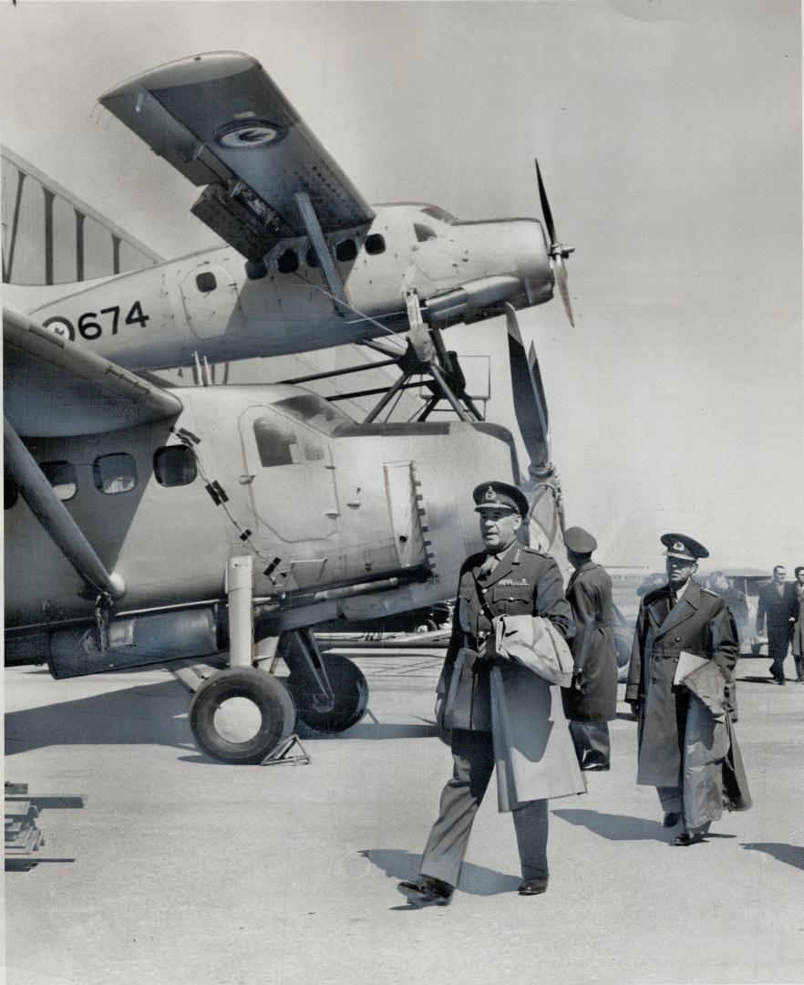 Experimental Plane which appears to be piggy-back affair is examined by senior NATO officers at the de Havilland plant