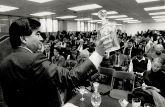 What's your bid? Larry Suzuki auctions off a decanter before a crowd of curiosity-seekers who turned up at the Osler offices on Adelaide St. yesterday(...)