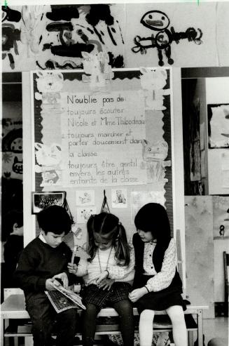 Sharing a story: Among senior kindergarten youngsters enrolled in French immersion at East York's Northlea Public School are, above left to right, Jason McQuoid, Lisa Angeli and Emma Munro