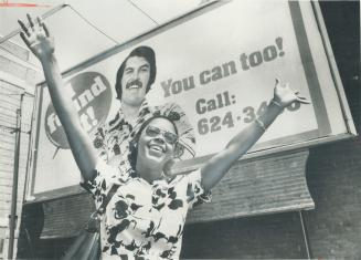 Juliet Allman spreads her arms in joy in front of one of the many billboards in the Toronto area inviting people to find religion. Mrs. Allman, of Sca(...)