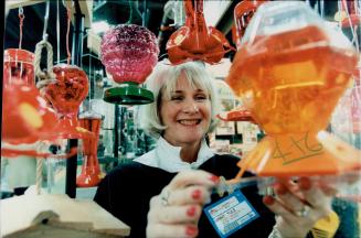 Ginny Yule with her display of Hummingbird feeders at home - Improvement trade show