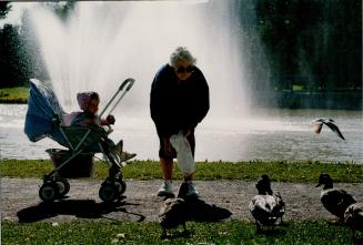 Crackers for quackers: Theresa scully, of Ireland, and grand daughter Keelin, 1, feed the ducks at Urban River Circle in Newmarket