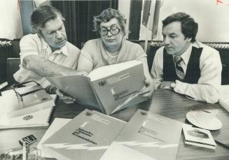First of seven volumes covering final report of LaMarsh Commission is reviewed by head commissioner Judy LaMarsh and colleagues Scott Young (left) and(...)