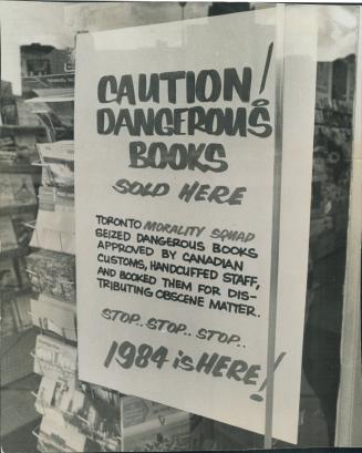 Handcuffs lock a book store. This closed sign on door of Reid Book Store, on King St., follows two police raids on the store last week, in which emplo(...)