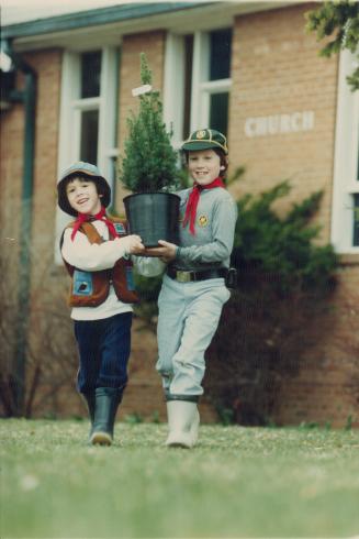 Tree-Mendous Effort. Craig McIntosh, 6, (left) a Beaver, and his brother Andrew, 8, a Wolf Club in Scarborough, will plant this seedling Saturday under the Trees for canada project