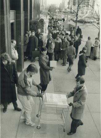 A basket of budgets. The Bank of Canada building on University Ave. is the scene of the usual budget lineup as people pick up copies of Finance Minist(...)